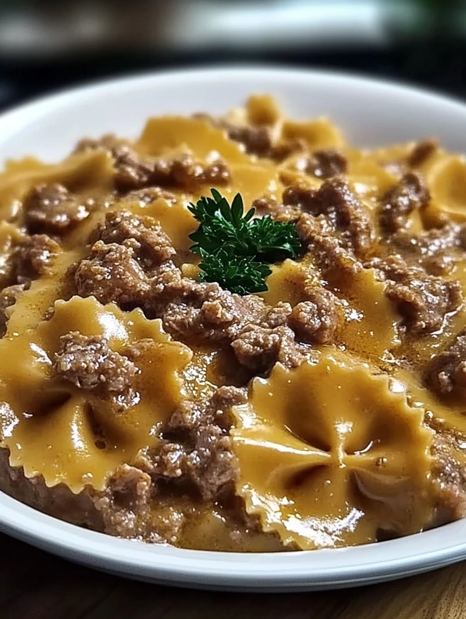 Un plat de farfalle avec une belle portion de viande par-dessus.