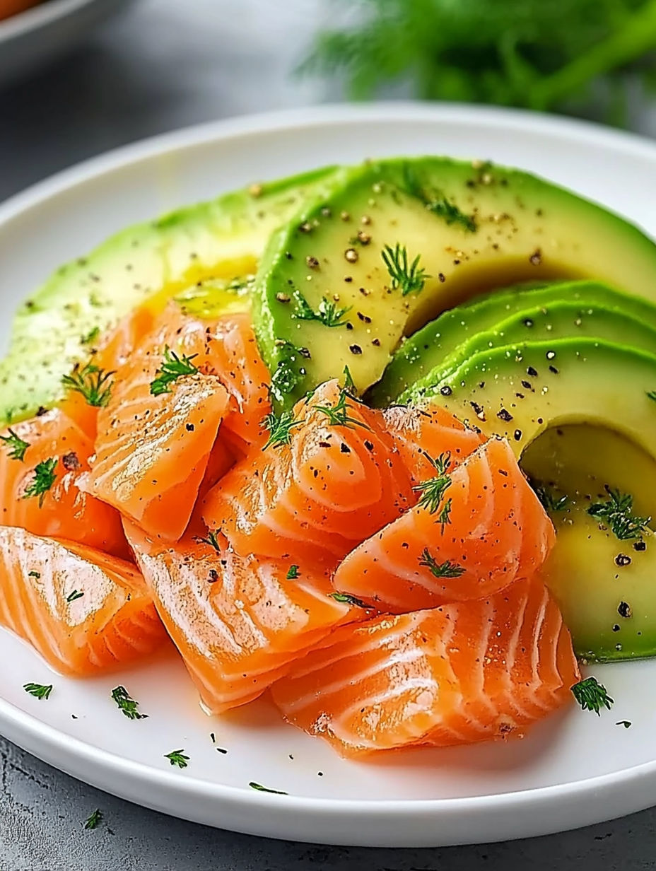 A plate of food with fish, avocado, and other vegetables.