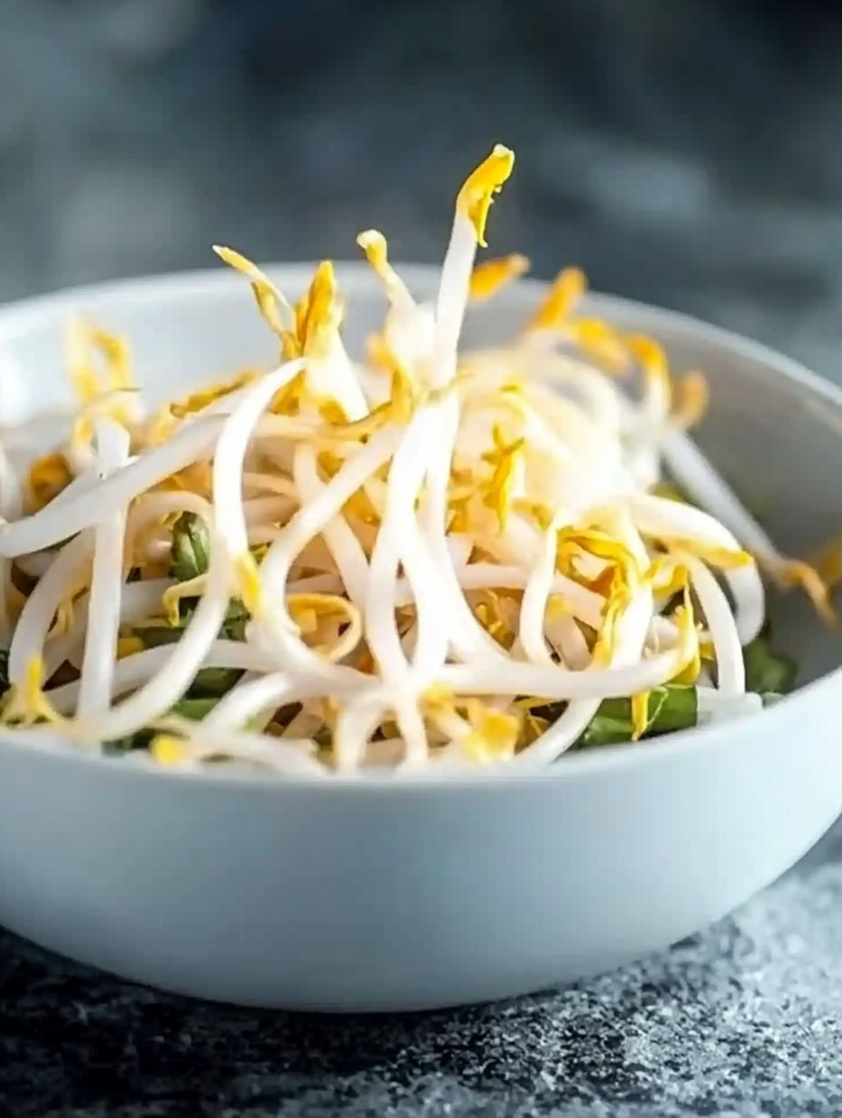 A bowl of noodles with a yellow sauce.