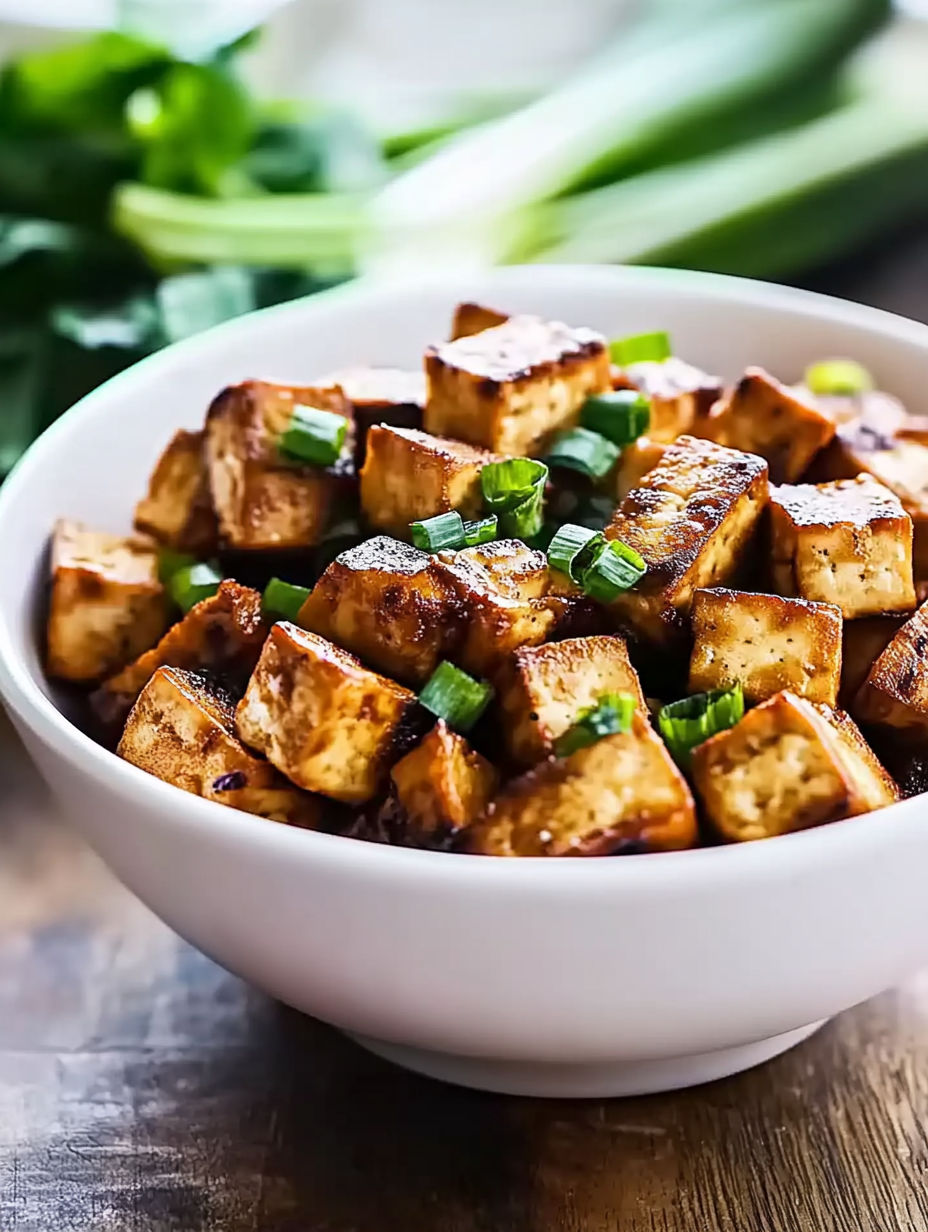 A bowl of food with a green vegetable on top.