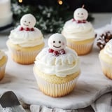 Cupcakes with white frosting and red berries.