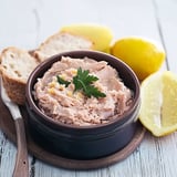A bowl of rillette de thon with a lemon wedge.